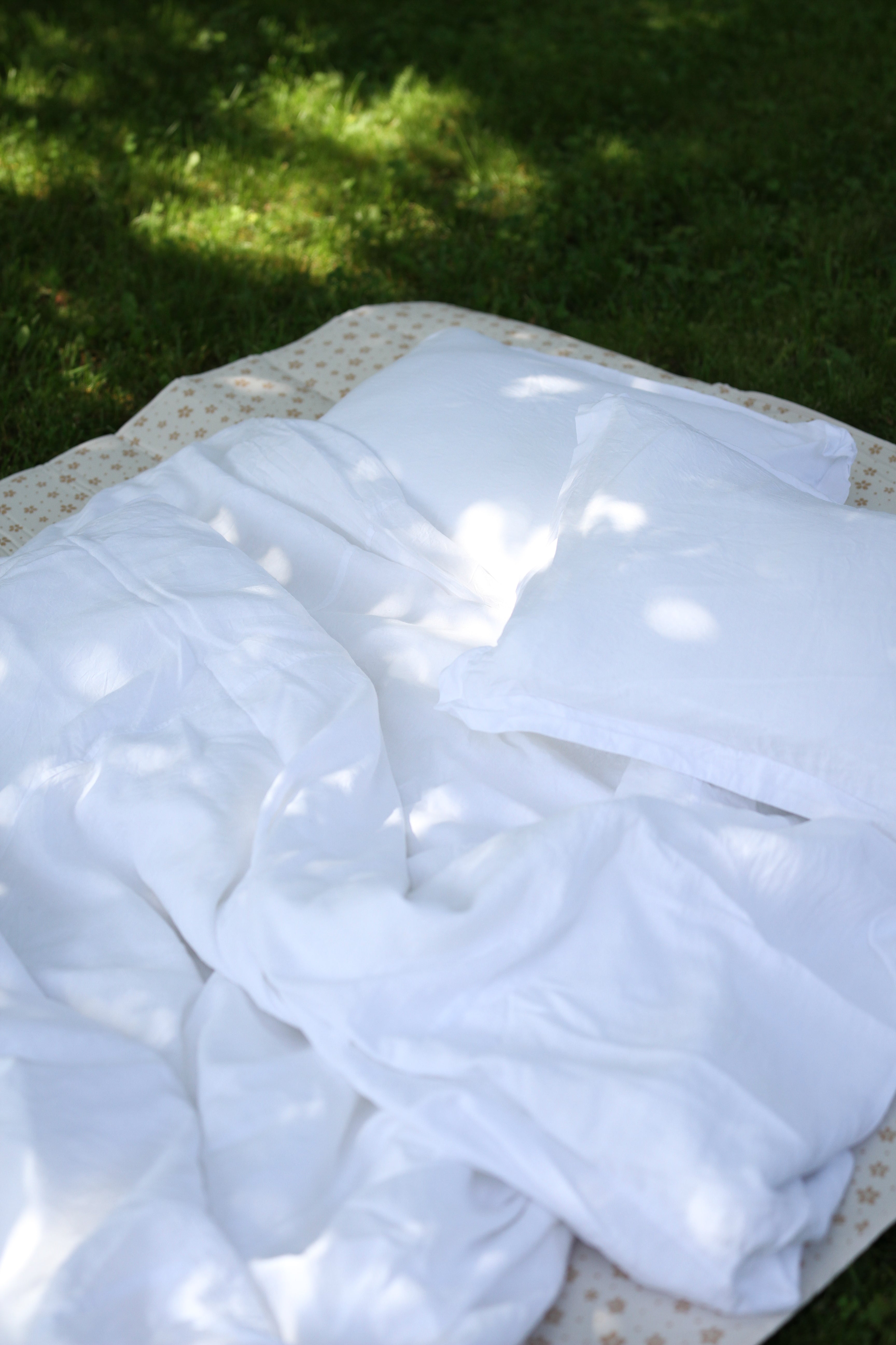 fairly linen, duvet and pillows in sunny garden on the grass